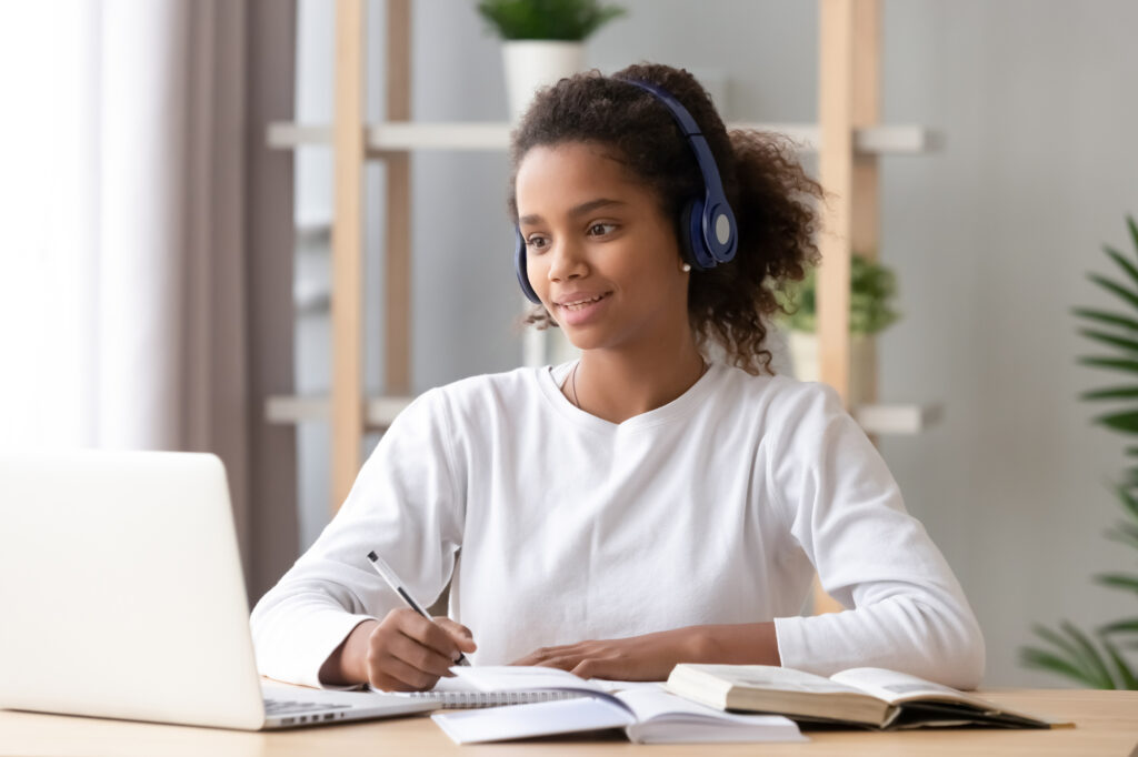 Girl Wearing Headphones And Studying Online